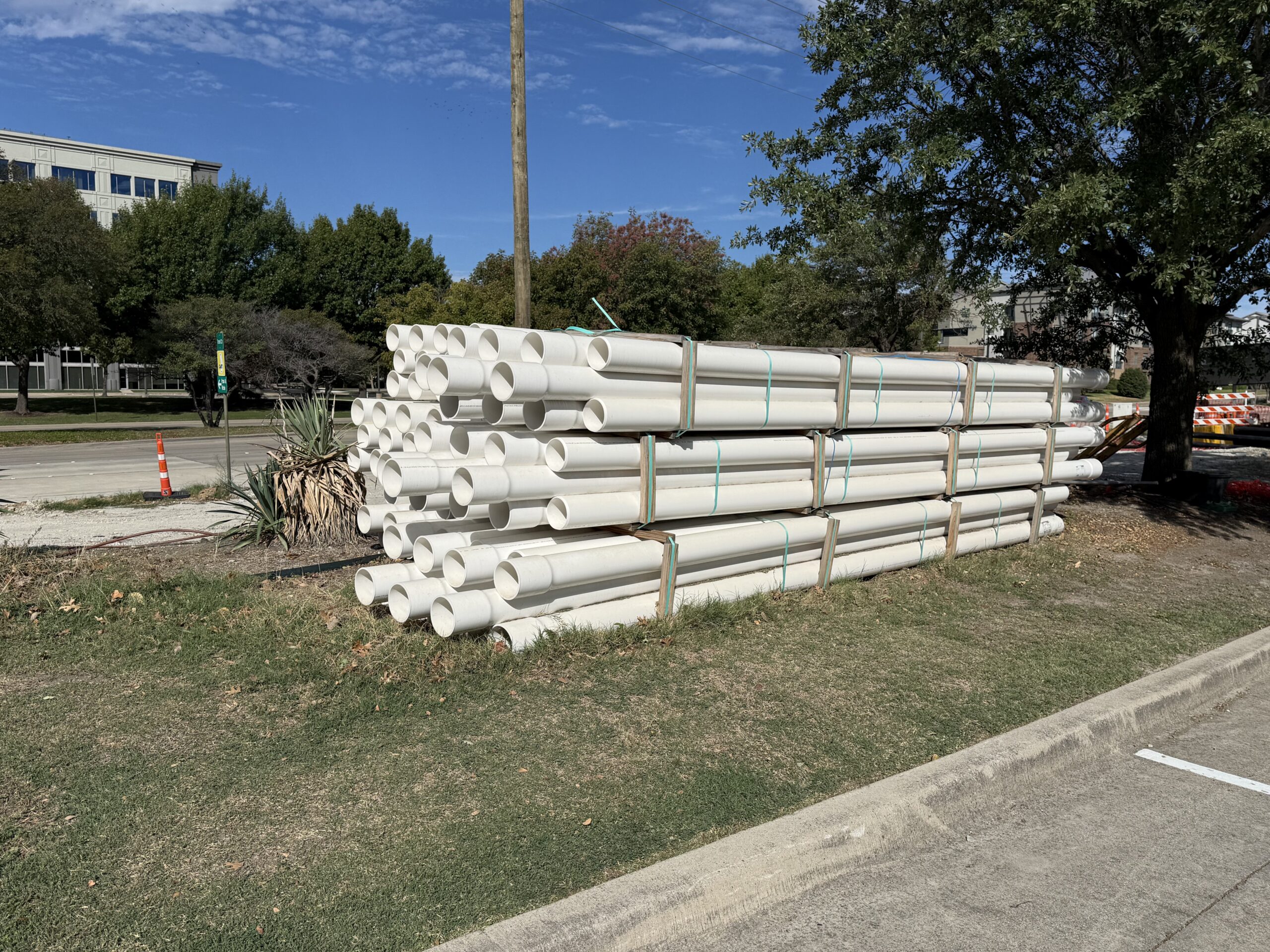 Large-diameter piping staged on racks for mechanical and infrastructure construction